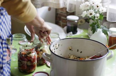 Close-up of woman preparing pickle at home