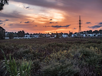 Scenic view of field against sky at sunset