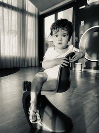 Portrait of boy sitting at home