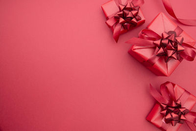 High angle view of christmas decorations on pink background