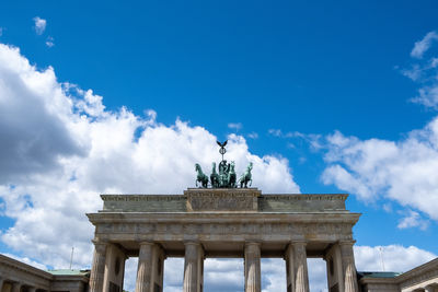 Low angle view of statue against cloudy sky