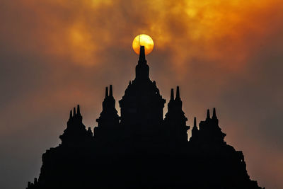 Low angle view of silhouette temple against sky during sunset