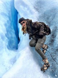 Woman climbing on glacier