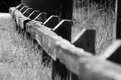 Wooden railing on field