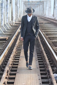 Man standing on railroad track