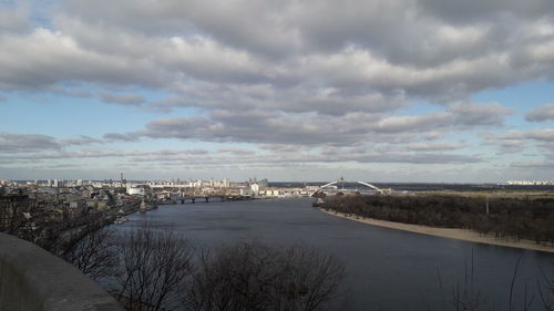 River amidst buildings in city against sky