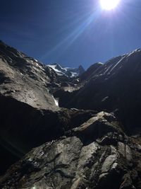 Scenic view of snowcapped mountains against sky on sunny day