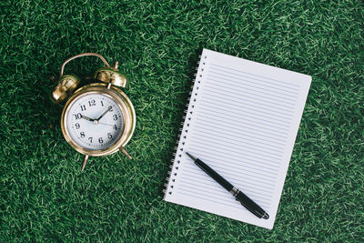 Blank notebook copy space with alarm clock