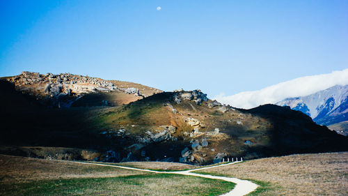 Scenic view of mountains against clear blue sky