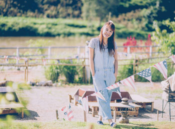 Portrait of a smiling young woman standing outdoors