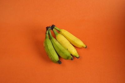 Close-up of bananas on orange background