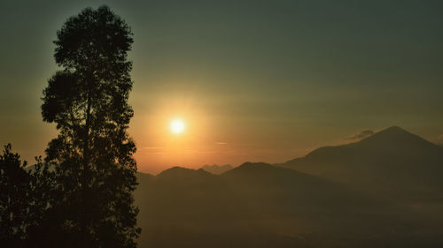 Scenic view of silhouette mountains against sky at sunset