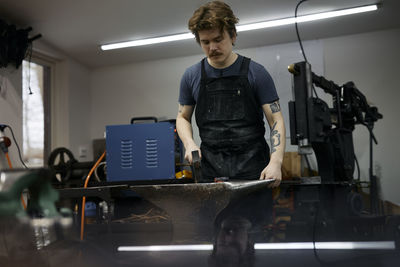 Blacksmith working in his workshop