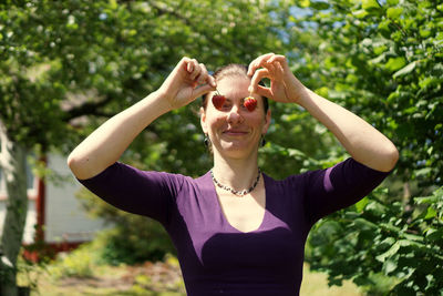 Portrait of a smiling young woman standing outdoors