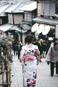 Rear view of women walking on street