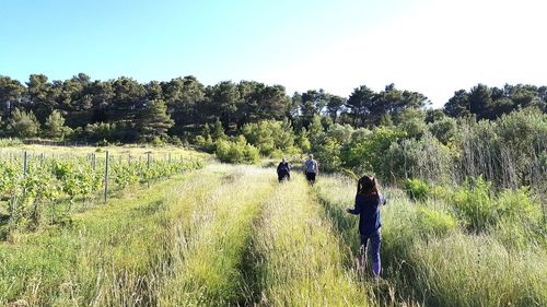 Family at farm against sky