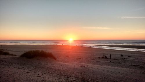 Scenic view of beach against sky during sunset