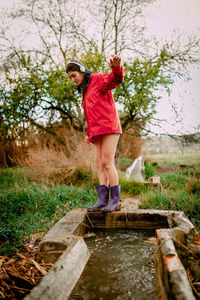 Full length of woman standing by water