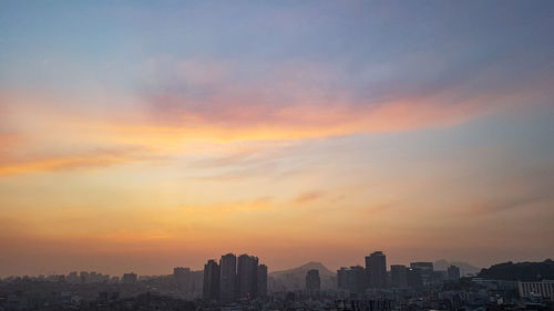 Buildings against sky during sunset