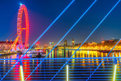 Illuminated suspension bridge in city at night