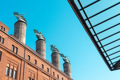 Low angle view of buildings against blue sky