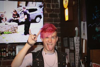 Portrait of young man  standing in bar