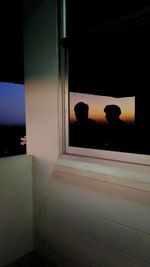 People in window at night