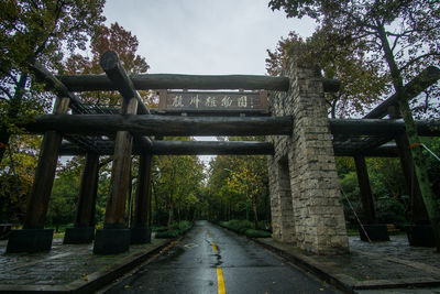 Empty road by bridge against sky