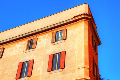 Low angle view of old building against blue sky