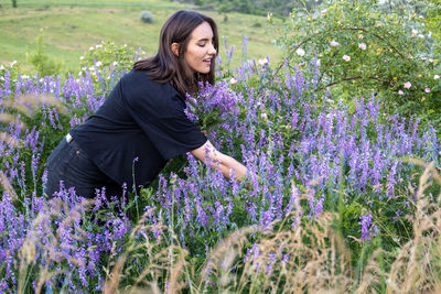 Young woman standing amidst plants