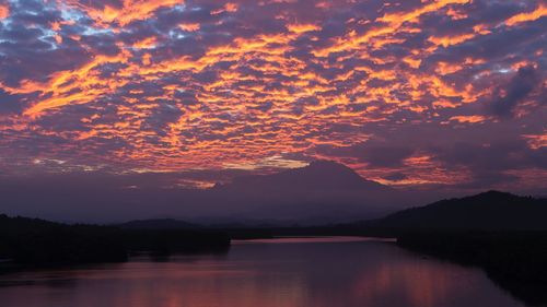 Scenic view of lake against romantic sky at sunset