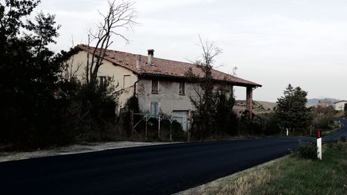 Building by road against sky