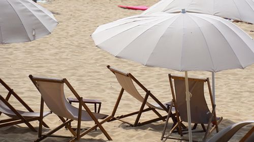 Deck chairs and parasols on beach