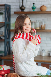 Cute smiling little child girl eating chocolate biscuits and drinking hot cocoa