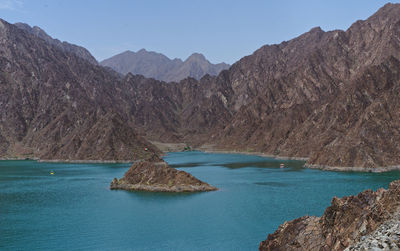 Scenic view of lake and mountains against clear sky