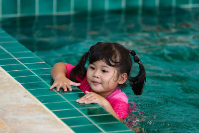 Portrait of cute girl in swimming pool