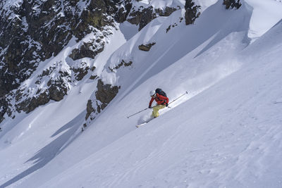 Person skiing on snowcapped mountain