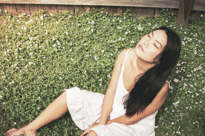 Young woman lying on grass