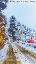 Road passing through snow covered landscape