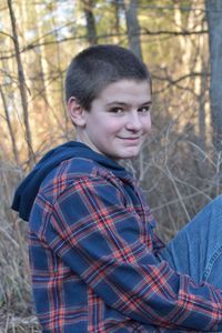 Portrait of smiling boy in forest