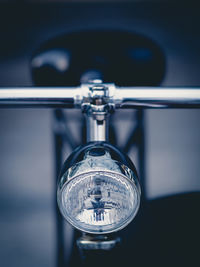 Close-up of headlight on bicycle parked outdoors