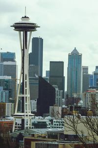 Skyscrapers against cloudy sky