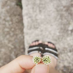 Low section of woman holding buds