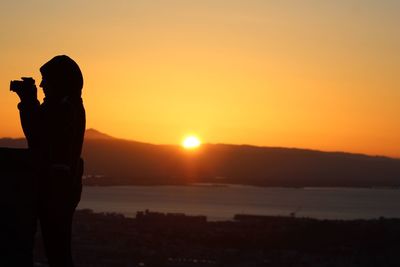 Silhouette of people at sunset