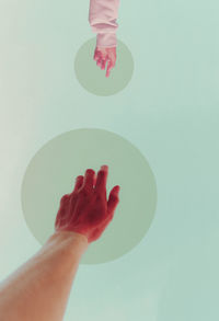 Low section of woman with hand over white background