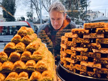 A man looks at a showcase with turkish sweets