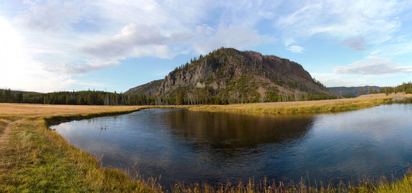 Scenic view of lake and mountains against sky