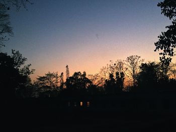 Silhouette trees against sky during sunset