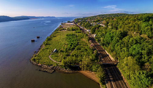 High angle view of sea and trees against sky