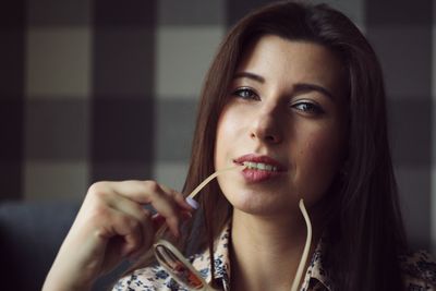 Portrait of young woman holding camera